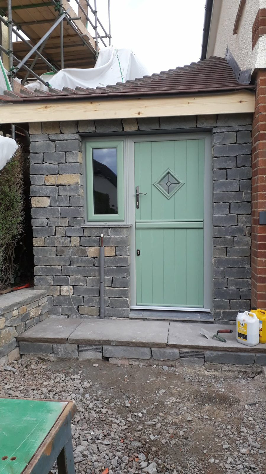 Stonework and green door exterior finish